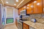 Remodeled kitchen with granite countertops, custom cabinets, stainless appliances